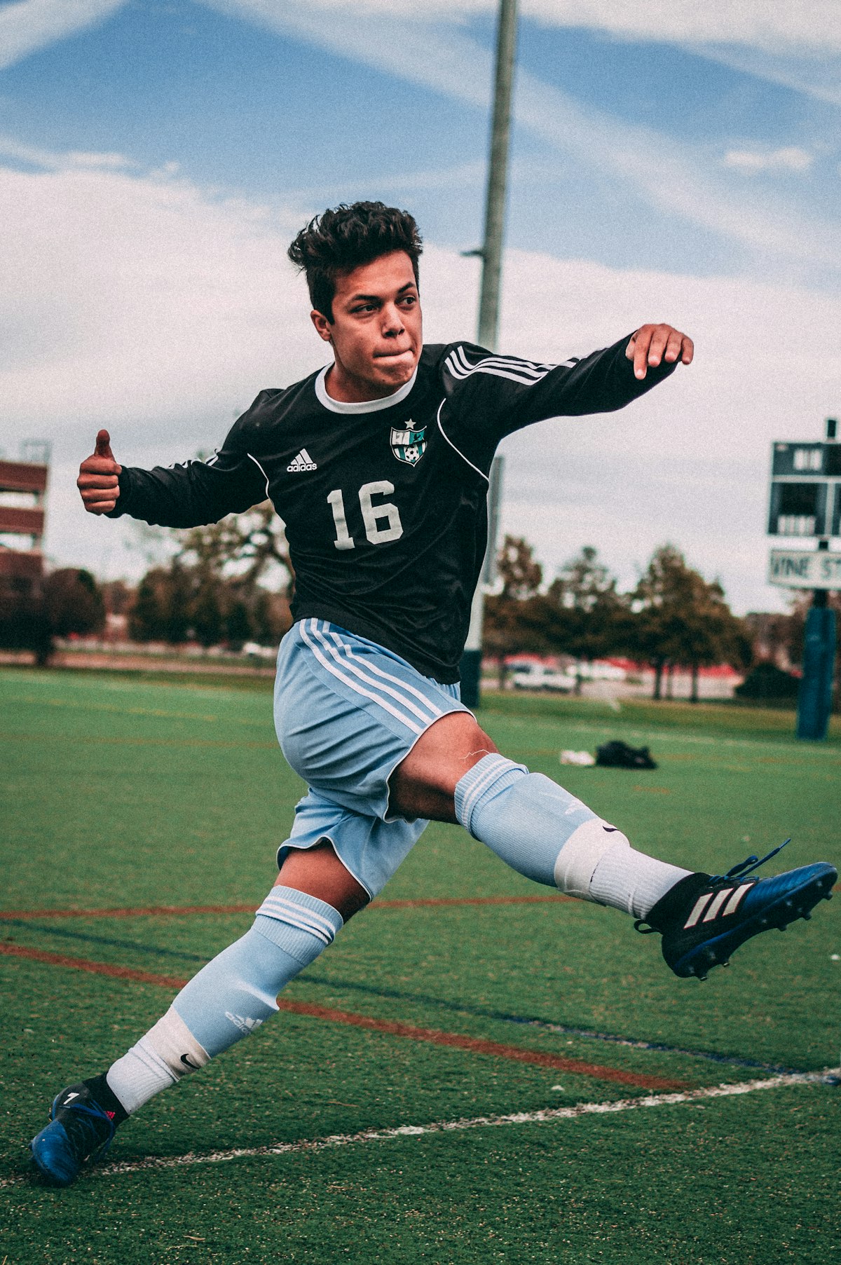 Soccer player kicking a ball and giving a thumbs up, illustrating English sports idioms