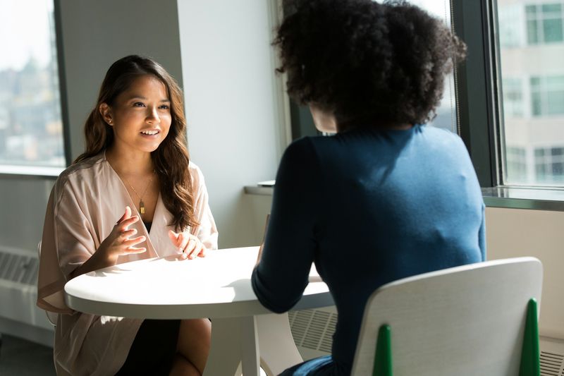 Two ESL students in a pair-work conversation to increase student talking time