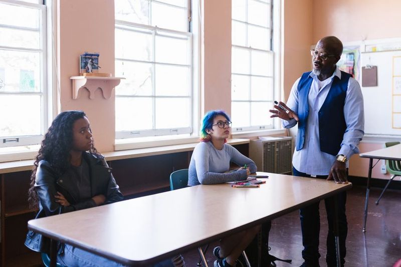 Teacher engaging students in classroom debate activity