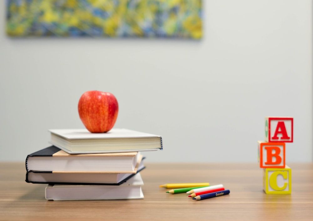 Books and ABC blocks representing the basics of teaching English to beginners