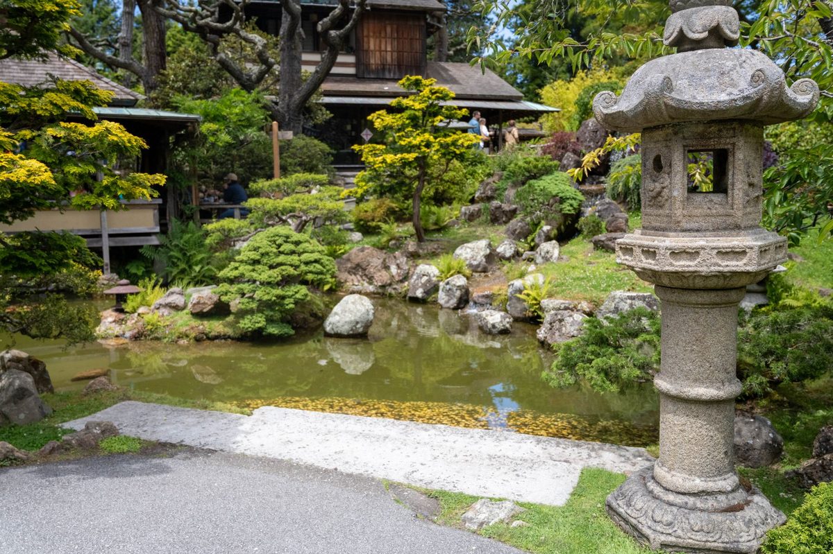 Serene Japanese garden scene featuring a traditional stone lantern and pond.