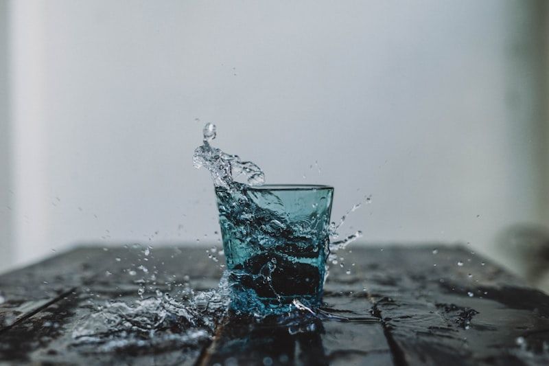 Glass of water splashing to show uncountable nouns