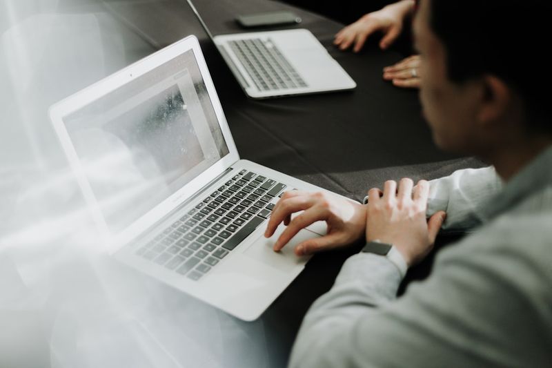 Business email opening phrases on a screen in an office
