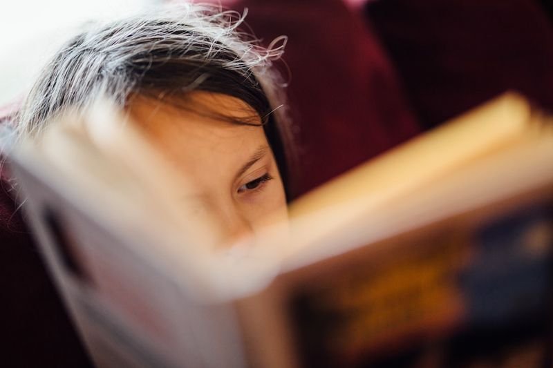 ESL homework idea — student reading English book for practice