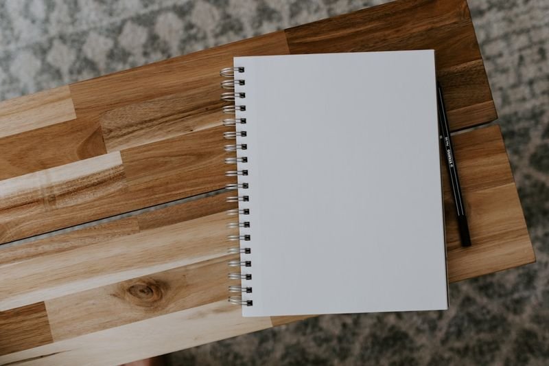 ESL homework idea — student writing in English journal notebook
