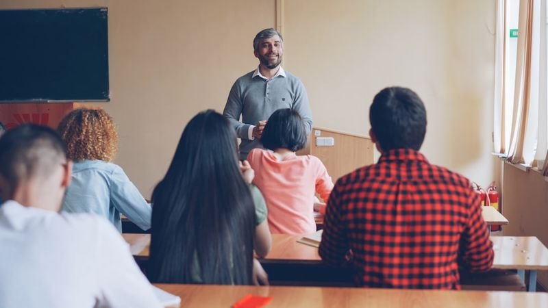 ESL teacher helping students practice wh-question formation