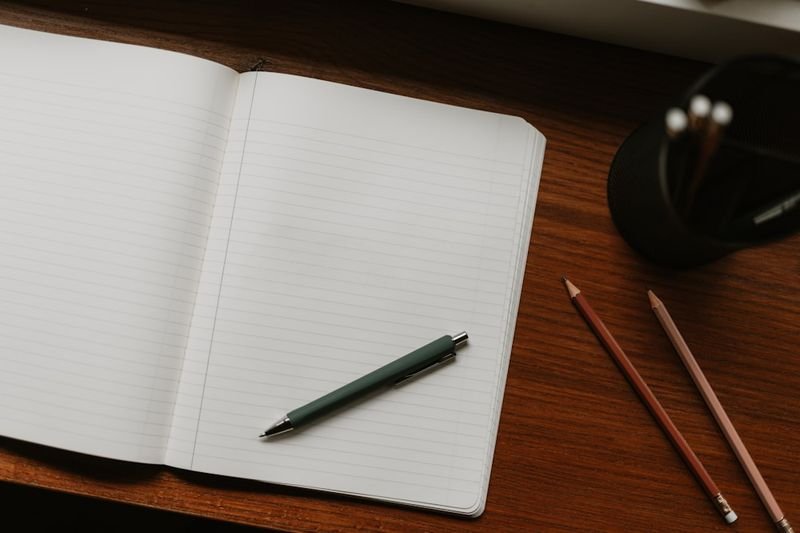 open notebook with pen for ESL writing error correction and capitalization exercises