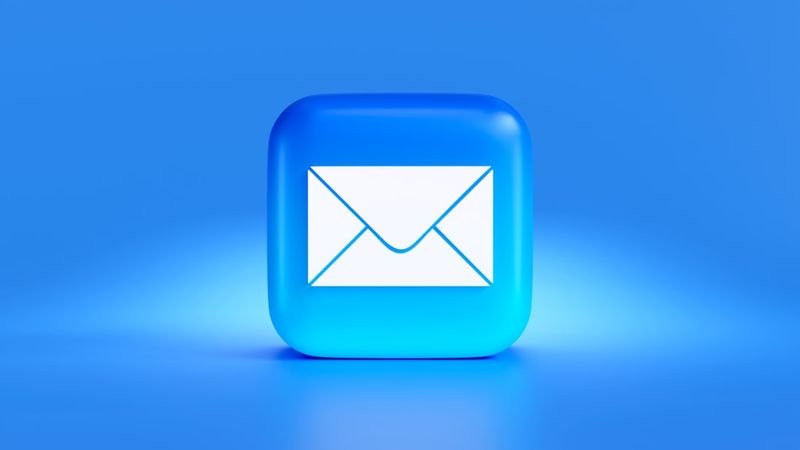Professional writing a business email at a laptop