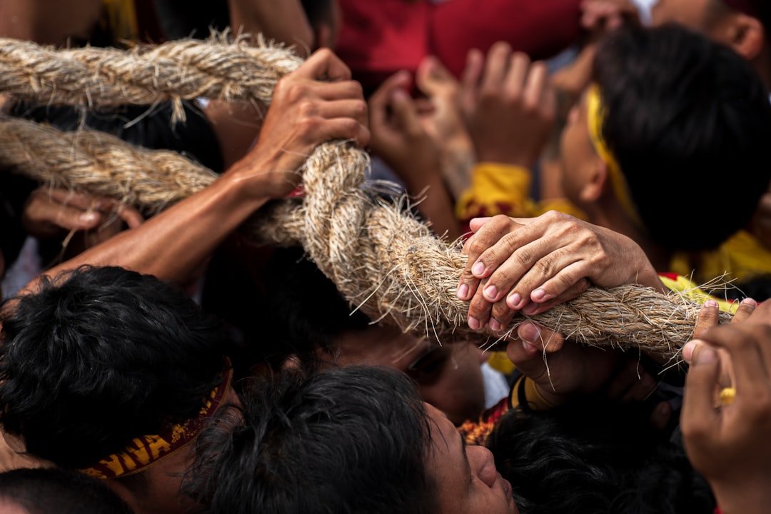 People pulling a thick rope together