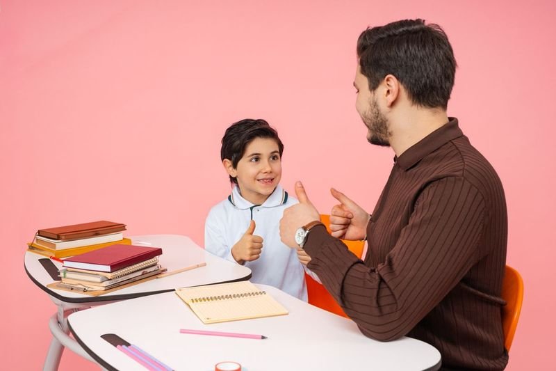 teacher giving one on one writing feedback to student