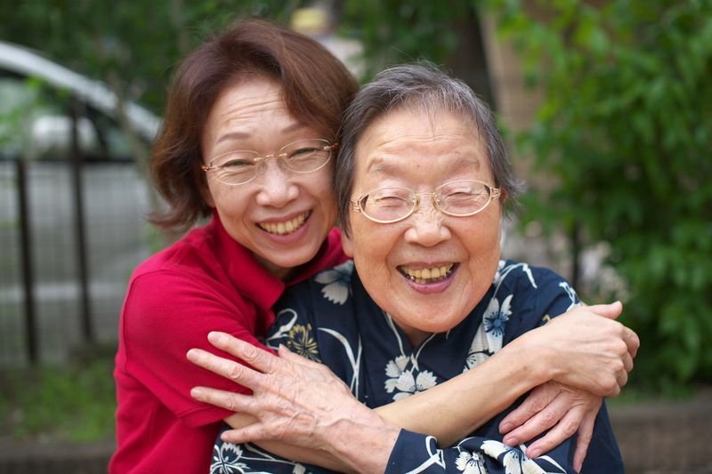 Mother and daughter hugging illustrating flesh and blood family idiom