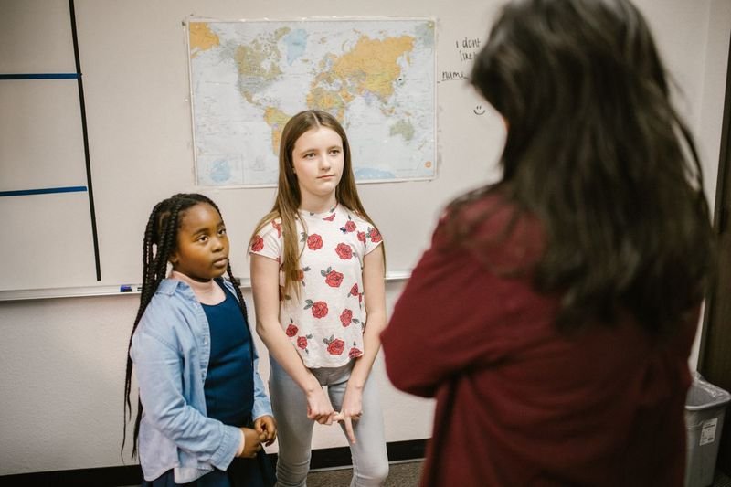 Freeze frame ESL drama activity — students frozen mid-scene in class