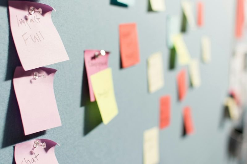 Colorful sticky notes on a wall used for a silent discussion gallery walk in ESL class