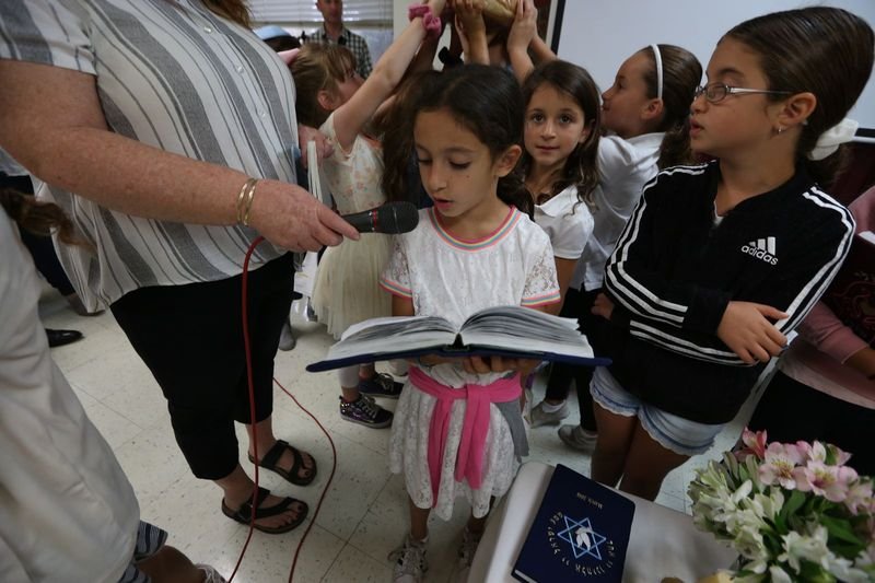 ESL students reading aloud together as part of a reader's theatre classroom activity