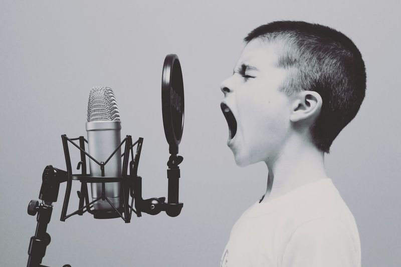 Student recording their voice during a shadowing technique pronunciation drill