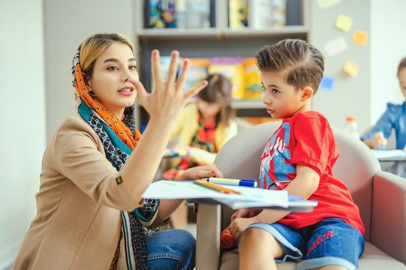 Teacher using visual communication with a deaf ESL student