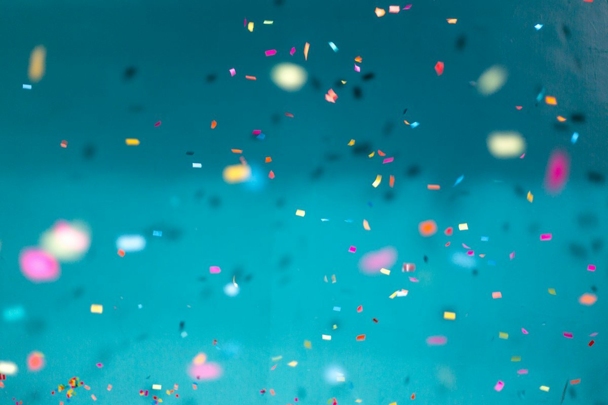 Balloons and confetti scattered at a lively party, illustrating paint the town red and have a ball