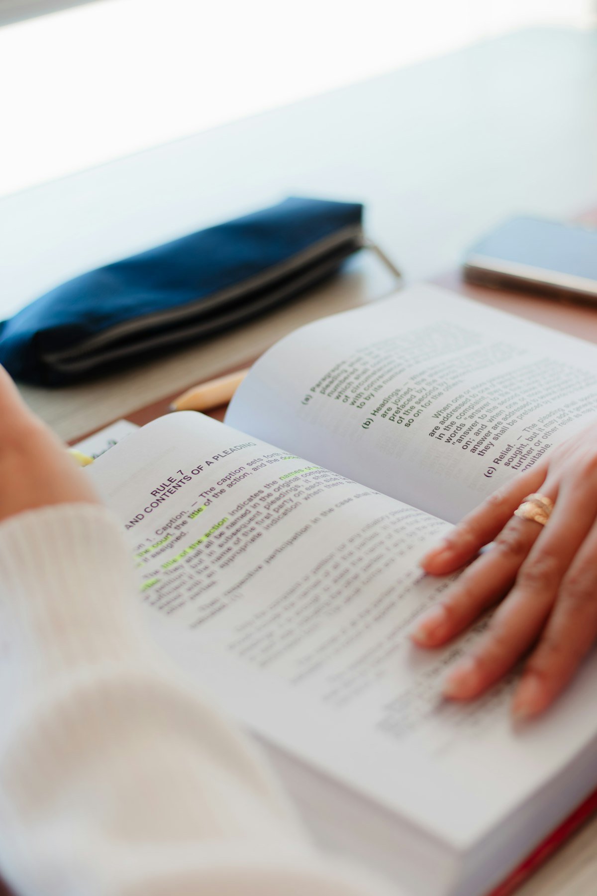 Person closely reading a document, illustrating read between the lines