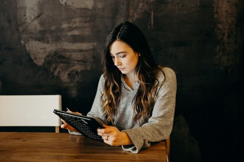 teacher reviewing Duolingo for Schools dashboard on tablet
