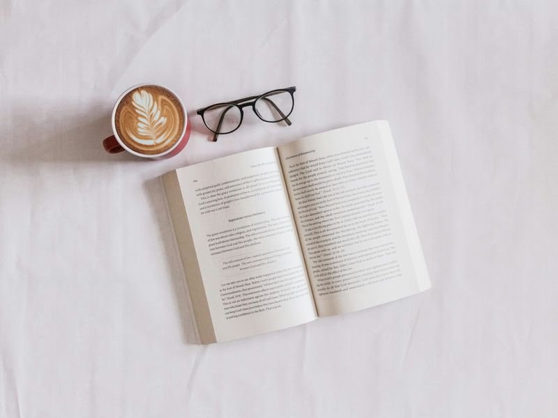 Dyslexia-friendly reading book with glasses on the page