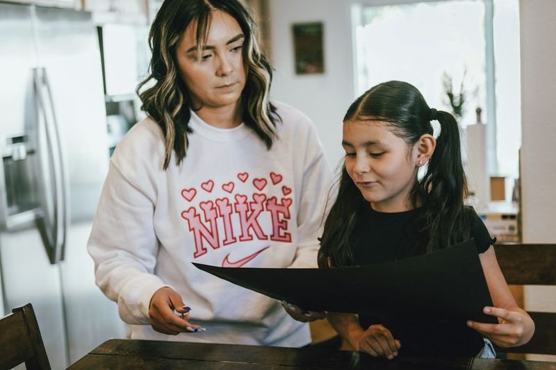 Parent helping an ESL student with homework at home