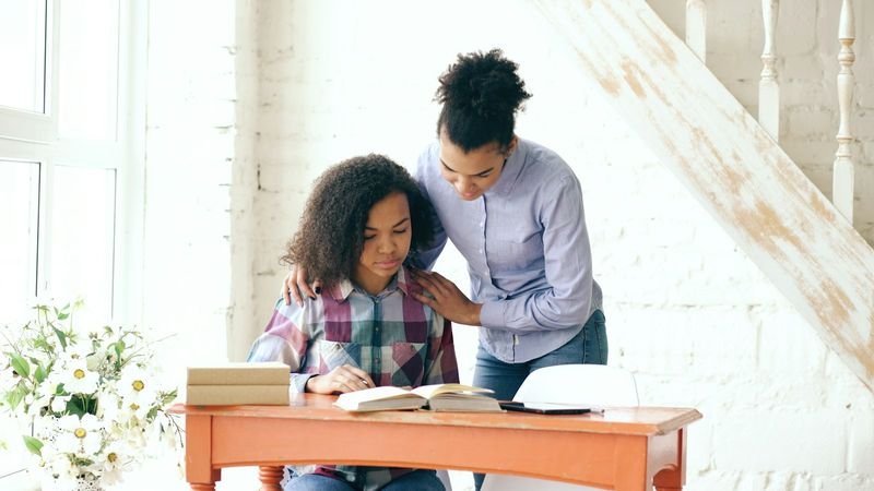 Teacher giving one-on-one support to an ESL student with anxiety