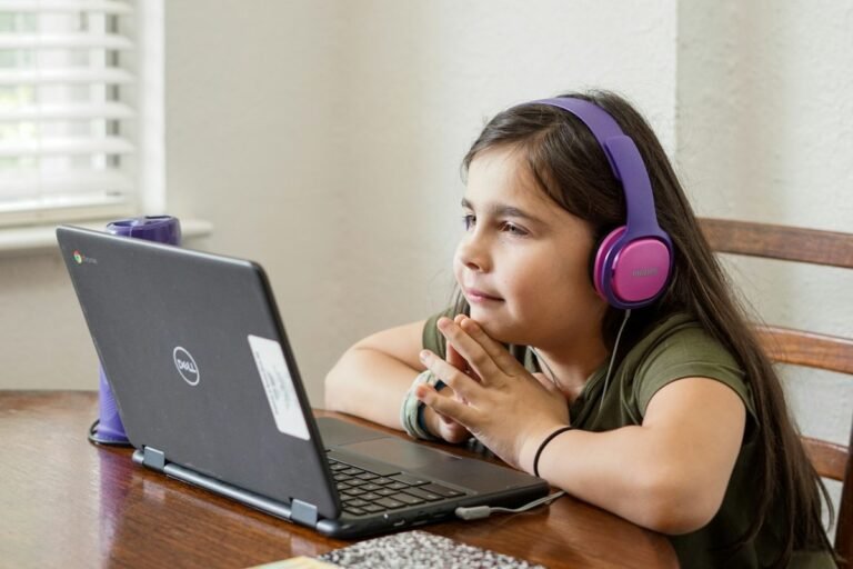 Young ESL student completing an interactive LiveWorksheets exercise on a laptop