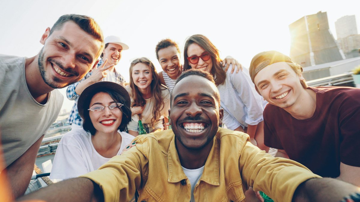 Diverse group of friends smiling outdoors, illustrating birds of a feather flock together