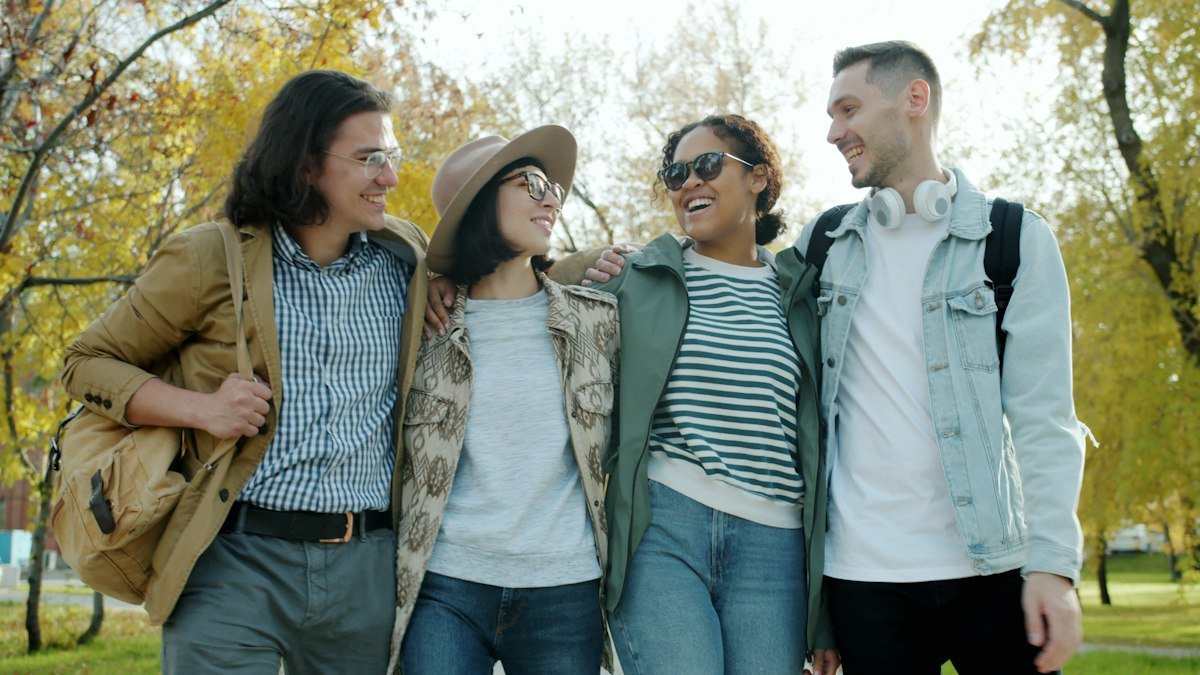Four friends walking together through hard times, illustrating through thick and thin
