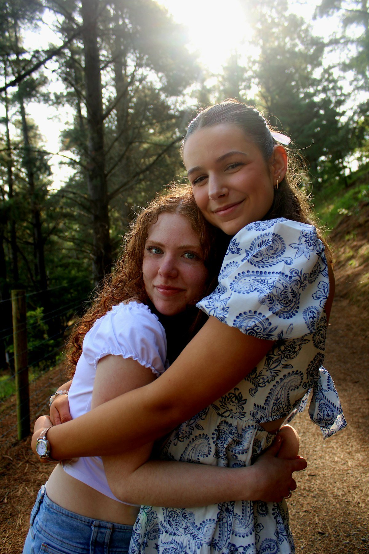 Two friends hugging for comfort, illustrating a shoulder to cry on