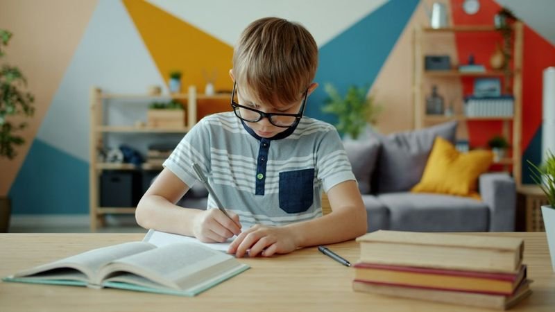 Student writing in a journal for intrapersonal intelligence ESL reflection
