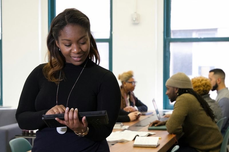 Teacher setting up a Nearpod interactive lesson on a tablet for an ESL class