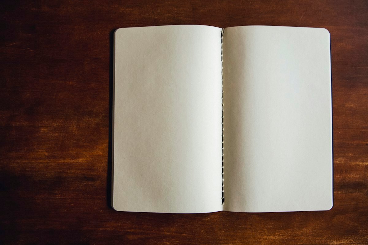 Blank, unwritten notebook pages, illustrating the idiom draw a blank