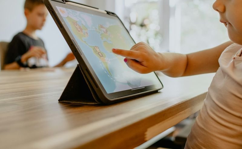 Young learner interacting with a digital activity on a tablet
