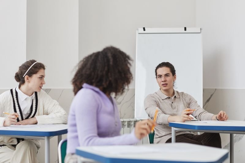 ESL students engaged in peer correction and self-monitoring, a Silent Way classroom technique