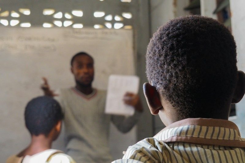 Teacher facing a deaf ESL student directly for lipreading support
