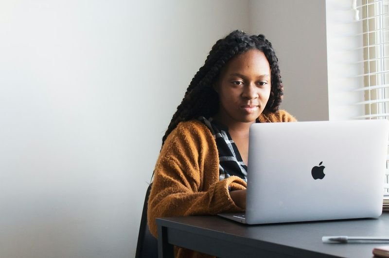 ESL student using a laptop for assistive technology under UDL techniques for action and expression